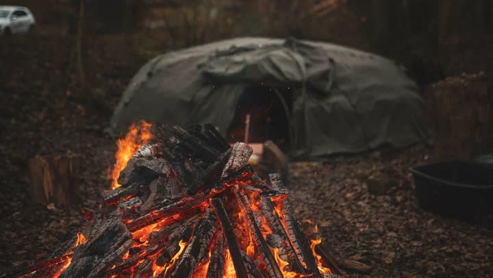 A fire in front of the sweat lodge